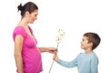 Little boy offering flower to his mom