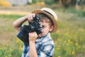 Young photographer in a straw hat with old camera Royalty Free Stock Photo