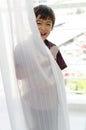 Little boy opening the door curtain Royalty Free Stock Photo