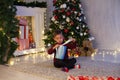 Little boy opens Christmas presents new year Christmas tree Garland Royalty Free Stock Photo