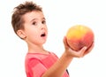 Little boy outstretch the peach Royalty Free Stock Photo