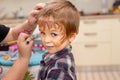 Little boy with painted face as a lion Royalty Free Stock Photo