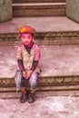 Little boy with a painted face celebrating Holi festival in India