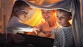 Little boy in pajamas playing with his family on tablet computer at night. Family having time together, children with gadgets, Royalty Free Stock Photo