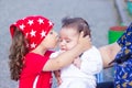The little boy in the park is kissing his newborn brother Royalty Free Stock Photo