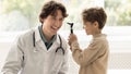 Small kid plays with doctor during consultation Royalty Free Stock Photo