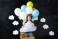 The little boy and pet dog sitting in a basket of balloon Royalty Free Stock Photo