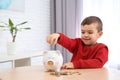Little boy with piggy bank and money Royalty Free Stock Photo