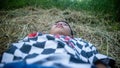 a little boy on a pile of dry hay