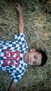 a little boy on a pile of dry hay