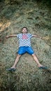 a little boy on a pile of dry hay