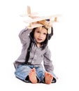 Little boy with pilot hat playing toy plane Royalty Free Stock Photo