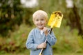 Little boy planting tuya bushes in the yard. Seasonal works in the garden. Landscape design. Child is helping parents in the Royalty Free Stock Photo