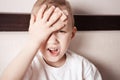 Little boy with plaster on head, doesn t feel well and groans in pain Royalty Free Stock Photo