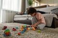 Little boy play with constructor near father sleep Royalty Free Stock Photo