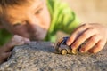 Little boy play with a toy car summer outdoor. Little kid plays outdoor with toy car Royalty Free Stock Photo