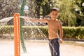 Little boy play on water playground in summer park Royalty Free Stock Photo