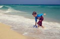 Little boy play with water on tropical beach Royalty Free Stock Photo