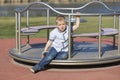 Little boy on a playground. Child playing outdoors in summer. Kids play on school yard. Happy kid in kindergarten or preschool. Royalty Free Stock Photo