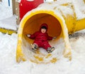 Little boy on the playground in winter day
