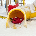 Little boy on the playground in winter day