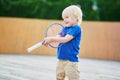 Little boy playing badminton with mom on the playground Royalty Free Stock Photo