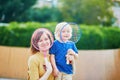 Little boy playing badminton with mom on the playground Royalty Free Stock Photo