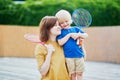 Little boy playing badminton with mom on the playground Royalty Free Stock Photo