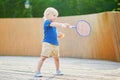 Little boy playing badminton on the playground Royalty Free Stock Photo