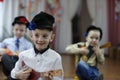 A little boy is playing a balalaika