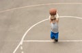 Little boy playing on a basketball court Royalty Free Stock Photo