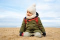 Little boy playing on beach in winter Royalty Free Stock Photo