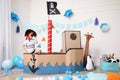 Little boy playing with binoculars in pirate ship at home. Child`s room interior Royalty Free Stock Photo