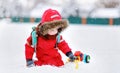 Little boy playing with bright car toy and fresh snow Royalty Free Stock Photo