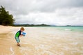 Little Boy Playing with a Bucket on the Beach