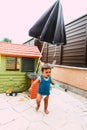 Little boy playing with bucket and water at home confinement covid19 Royalty Free Stock Photo