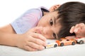 Little boy playing with car toy on the table alone Royalty Free Stock Photo