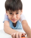 Little boy playing with car toy on the table alone Royalty Free Stock Photo