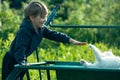 A little boy is playing with cat outdoors. Royalty Free Stock Photo