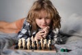 Little boy are playing chess at home. Kid thinking about chess. The concept of learning and growing children. Chess Royalty Free Stock Photo
