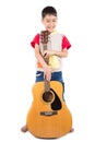 Little boy playing classic guitar course on white background