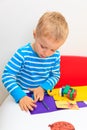 Little boy playing with clay dough