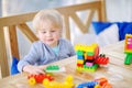 Little boy playing with colorful plastic blocks at kindergarten or at home Royalty Free Stock Photo