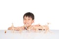 Little boy playing dinosaur fossil toy on the table indoor activities Royalty Free Stock Photo