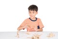 Little boy playing dinosaur fossil toy on the table indoor activities Royalty Free Stock Photo