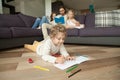 Kids drawing reading book with parents, family activities at hom Royalty Free Stock Photo