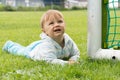 Little boy playing on the football field with gates Royalty Free Stock Photo