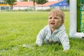 Little boy playing on the football field with gates Royalty Free Stock Photo