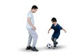 Little boy playing football with his father on studio Royalty Free Stock Photo