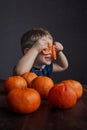 Little boy playing with fresh orange fruit Royalty Free Stock Photo